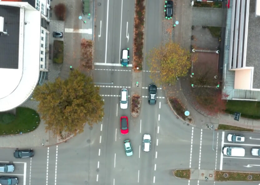 Aerial photo of cars driving on the road in a city.